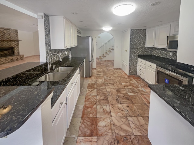 kitchen featuring sink, stainless steel appliances, and white cabinetry