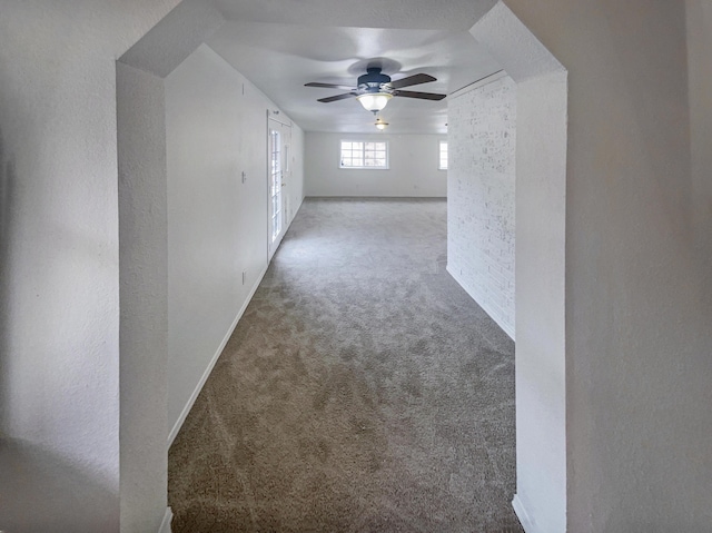 bonus room with light colored carpet and ceiling fan