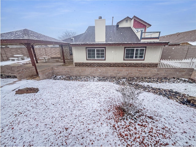 snow covered house featuring a gazebo