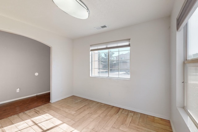 spare room with light parquet flooring