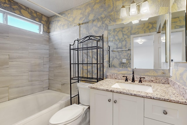 full bathroom featuring vanity, toilet, and tiled shower / bath combo