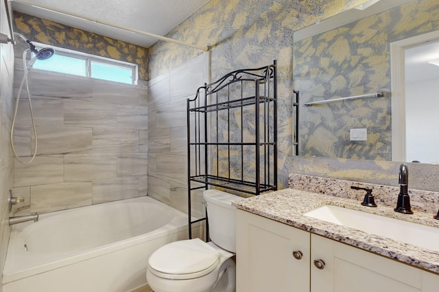 full bathroom with vanity, toilet, and tiled shower / bath combo