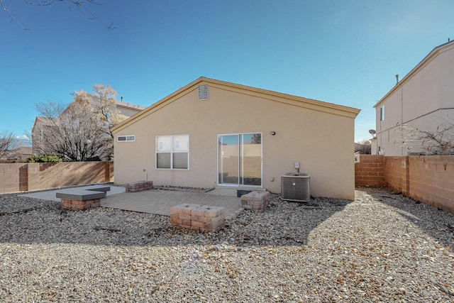 back of house featuring central AC unit and a patio area