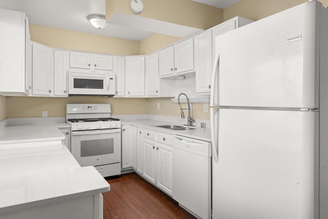 kitchen with white appliances, dark wood-type flooring, white cabinets, and sink