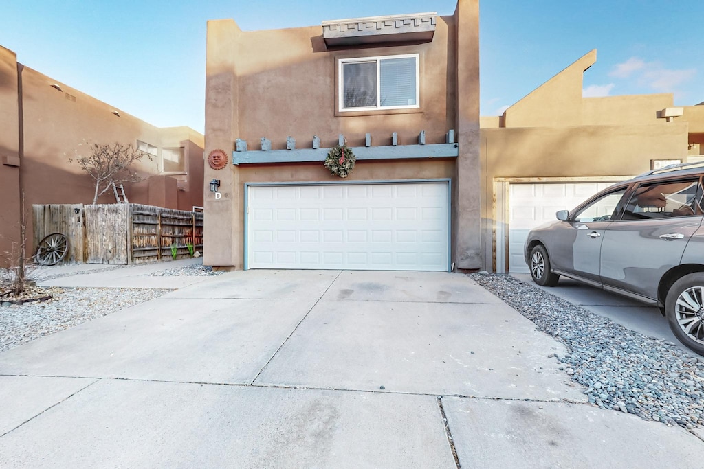 pueblo revival-style home with a garage