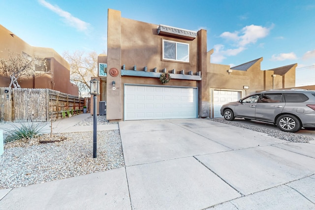 southwest-style home with central AC and a garage