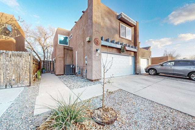 view of home's exterior with cooling unit and a garage