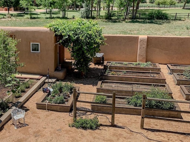 view of yard featuring fence and a vegetable garden
