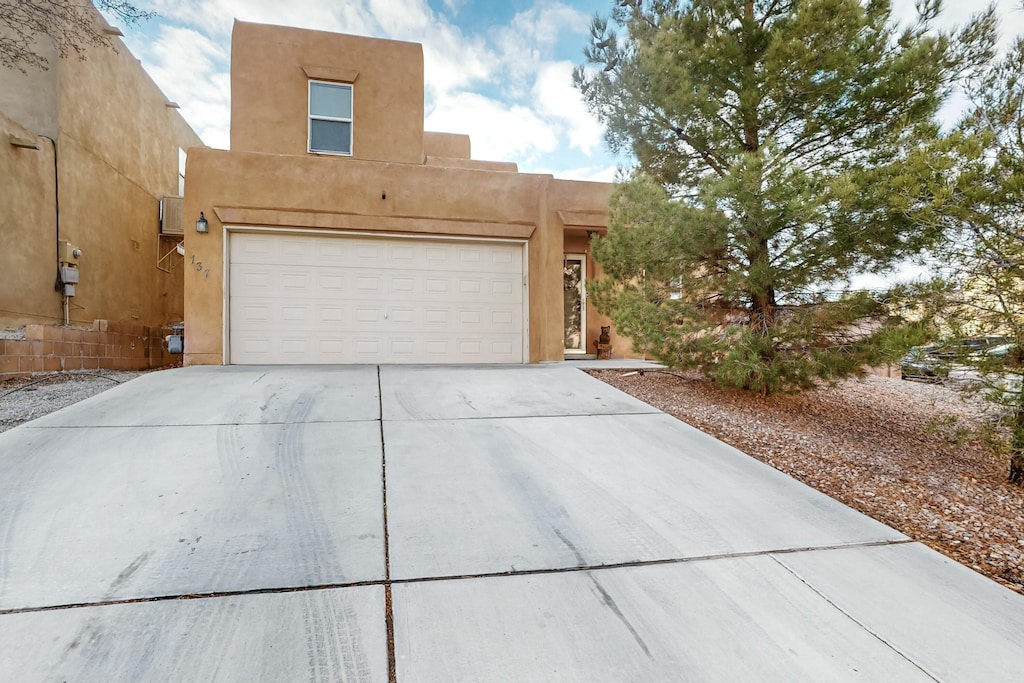 pueblo-style house with a garage