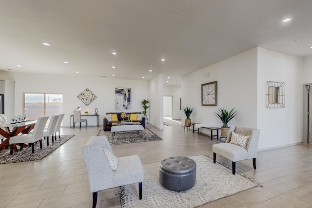 living area featuring recessed lighting and baseboards