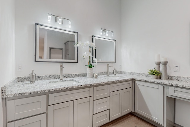 full bathroom featuring double vanity and a sink