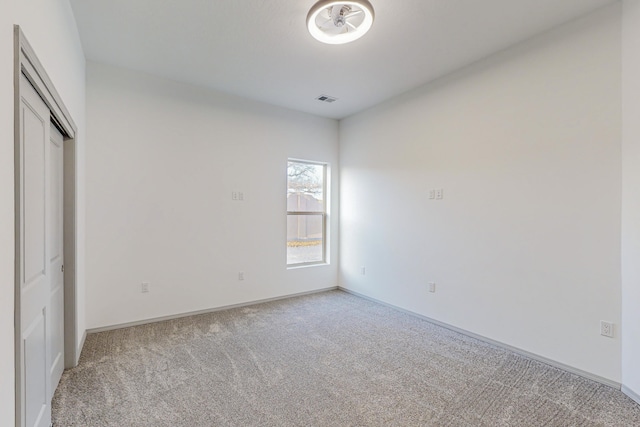 unfurnished bedroom featuring visible vents, light colored carpet, and baseboards