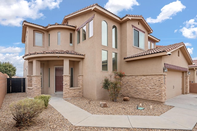 mediterranean / spanish-style home with a garage