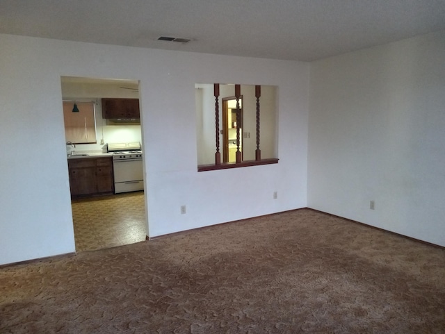 carpeted spare room featuring sink