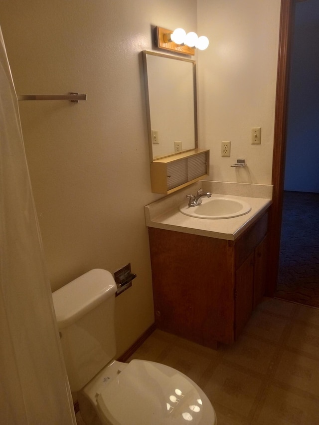 bathroom featuring toilet and vanity