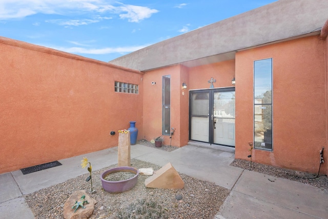 doorway to property with a patio