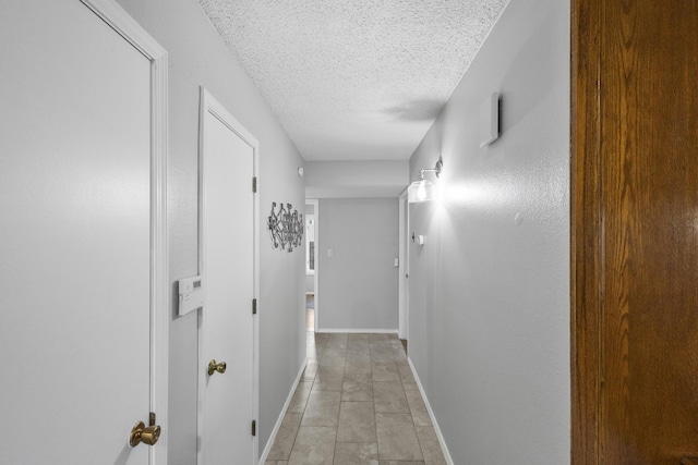 hall with a textured ceiling