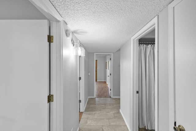 hallway with a textured ceiling