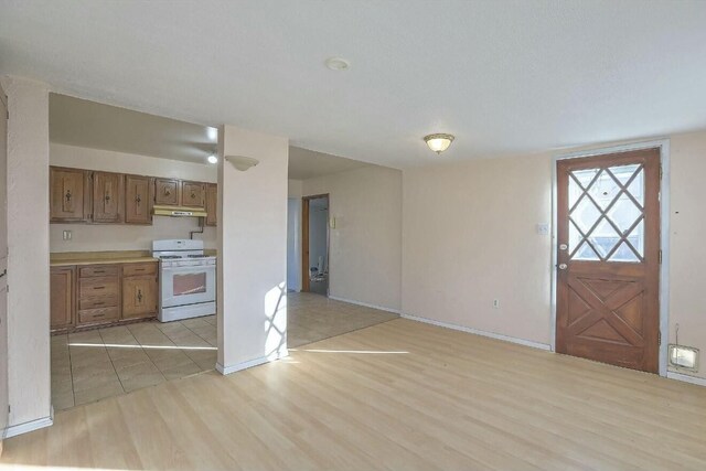 kitchen featuring light hardwood / wood-style flooring and white range with gas cooktop