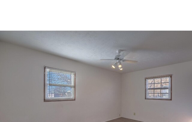 spare room with ceiling fan, carpet floors, and a textured ceiling