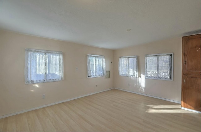 spare room with light hardwood / wood-style floors