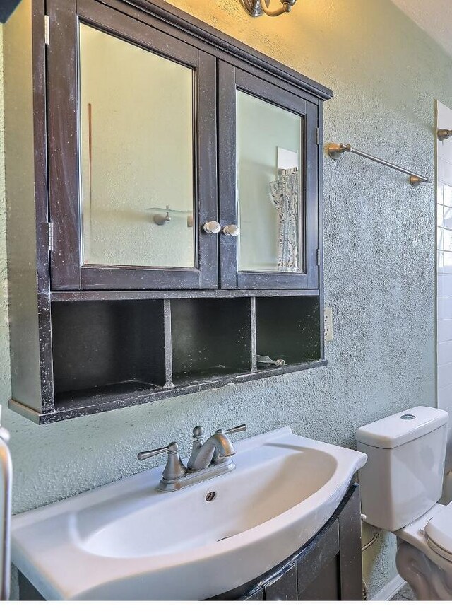 bathroom featuring toilet and vanity