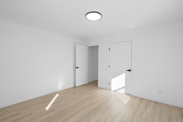 spare room featuring light hardwood / wood-style floors