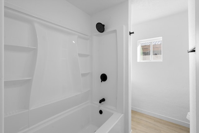 bathroom featuring shower / bathtub combination and hardwood / wood-style flooring