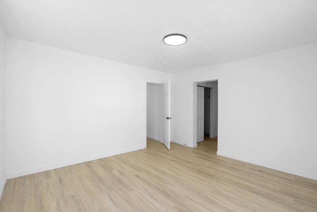 unfurnished room with light hardwood / wood-style flooring