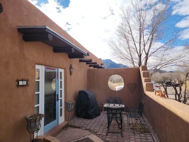 view of patio with a mountain view and a grill