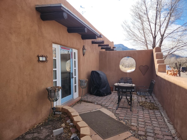 view of patio with a mountain view and area for grilling