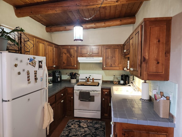 kitchen with tasteful backsplash, under cabinet range hood, tile countertops, wooden ceiling, and white appliances