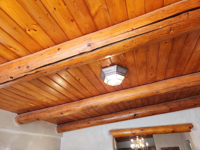 interior details with beam ceiling and a notable chandelier