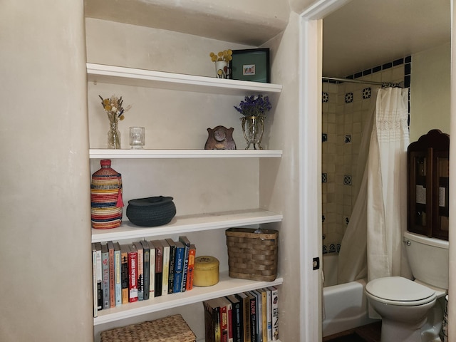 bathroom featuring built in shelves, toilet, and shower / bathtub combination with curtain