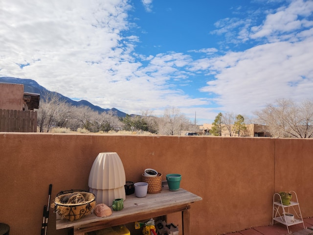 view of patio / terrace featuring a mountain view and a balcony