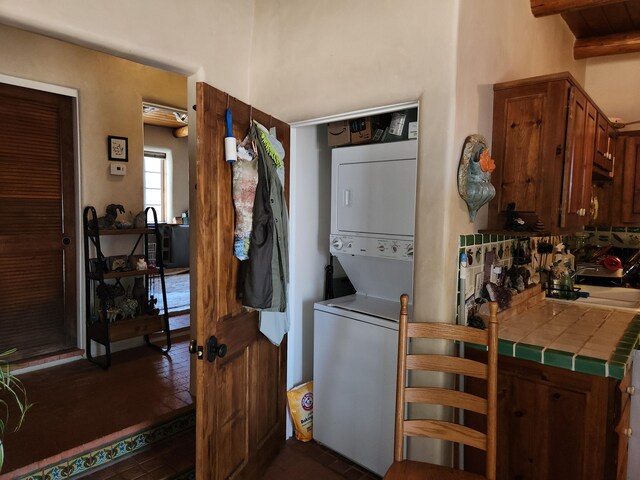 laundry room with stacked washer / dryer