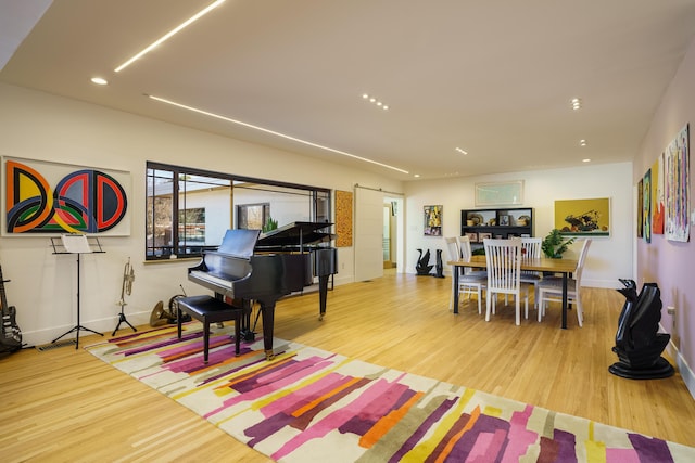 interior space featuring light hardwood / wood-style floors and a barn door