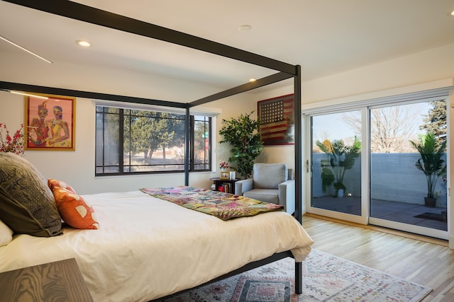 bedroom featuring access to outside and light hardwood / wood-style flooring