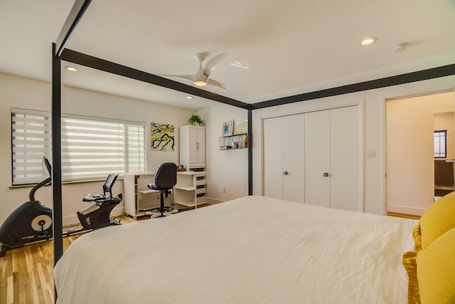 bedroom with a closet, ceiling fan, and light hardwood / wood-style floors