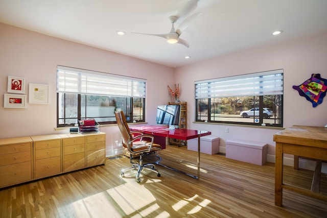 home office featuring light hardwood / wood-style floors and ceiling fan