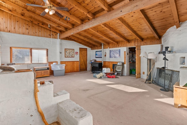 living room featuring wood ceiling, vaulted ceiling with beams, ceiling fan, and a wood stove