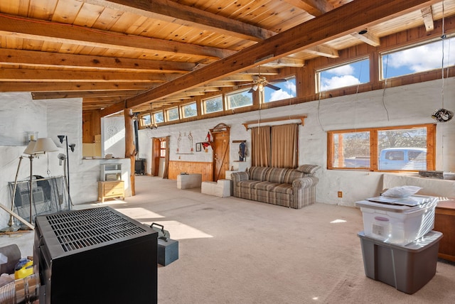 interior space with ceiling fan, wooden ceiling, beamed ceiling, and carpet