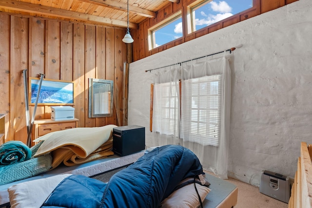 carpeted bedroom with wood ceiling, beam ceiling, and multiple windows