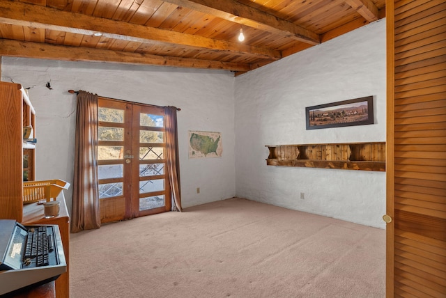 carpeted empty room with wood ceiling, beam ceiling, and french doors