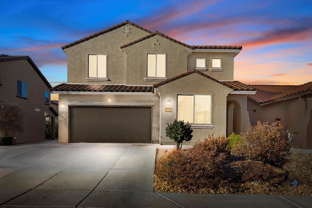 mediterranean / spanish house with a garage