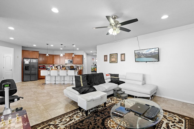 living room featuring ceiling fan and light tile patterned floors