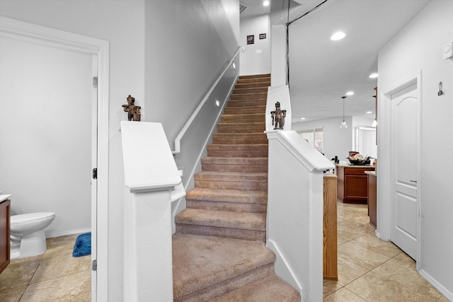 stairs with tile patterned flooring