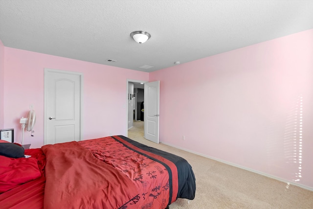 carpeted bedroom with a textured ceiling