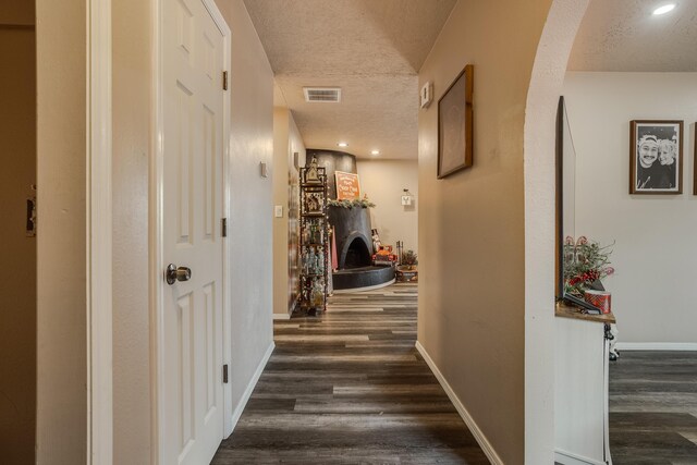 living room featuring dark wood-type flooring and a textured ceiling