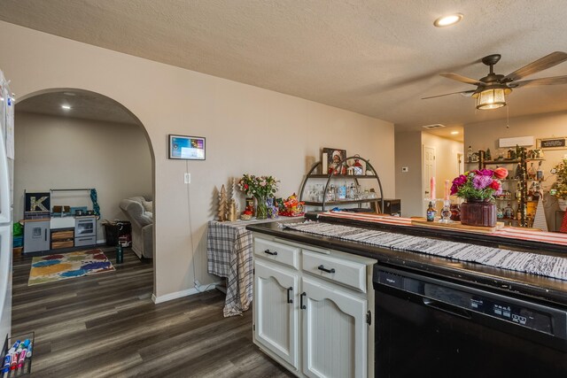 kitchen featuring white cabinetry, a textured ceiling, white appliances, kitchen peninsula, and a breakfast bar area